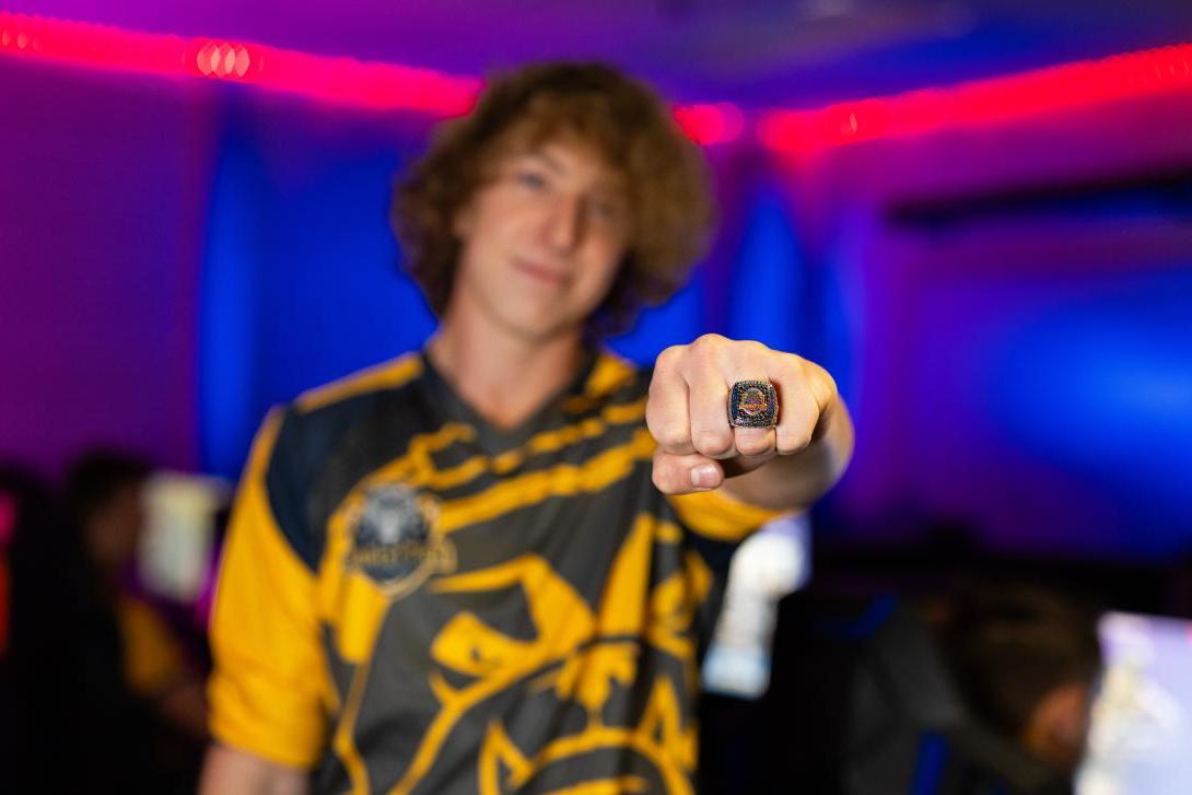 student showing esports championship ring